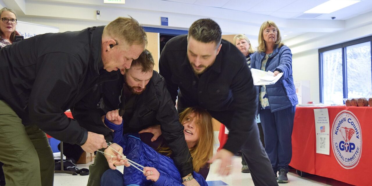 Idaho town hall meeting turns chaotic after woman is forcibly removed for heckling speakers