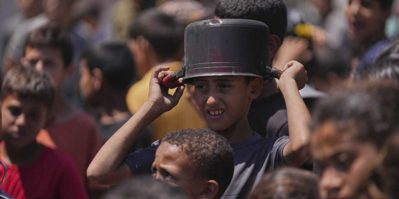 Hungry Palestinians in Gaza block and offload dozens of UN food trucks
