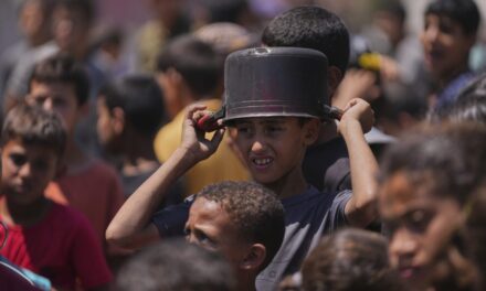 Hungry Palestinians in Gaza block and offload dozens of UN food trucks
