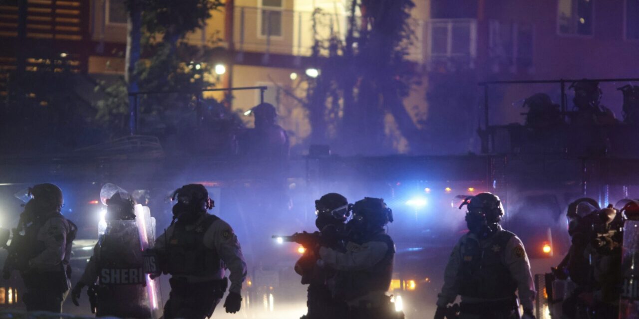 After tear gas and street fires, an Los Angeles community cleans up as National Guard troops arrive