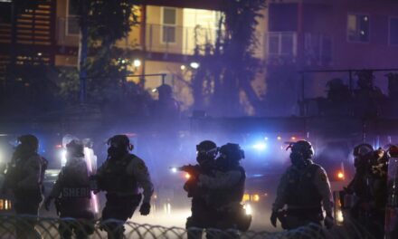 After tear gas and street fires, an Los Angeles community cleans up as National Guard troops arrive